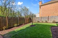 The treated wooden fence includes two gates for your convenience – a single gate located at the sidewalk running behind the garage and a swinging double-gate which provides access for your lawnmower. A separate courtyard offers extra outdoor space.