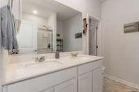 Primary bath offers double vanities and shower