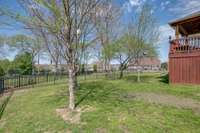 Spacious fenced backyard with extra storage under deck