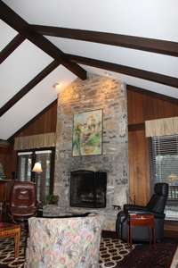 Beamed ceilings, family room off kitchen, stone fireplace