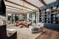 Fabulous family room with custom built-in cabinetry, solid brass library sconces, and a floor to ceiling Pella picture window.