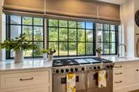 Large Pella kitchen windows overlooking the magnificently treed property.