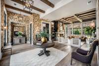 Breathtaking foyer and formal living room with a dramatic alcove feature and floor to ceilng 10' tall Pella architectural windows.