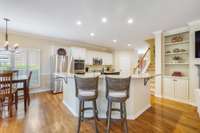 Recessed ceiling lights brighten up the kitchen. A roomy walk-in pantry tucked away in the corner grants handy access to out of sight food storage.