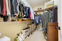 Located right off the bathroom, the walk-in closet in the Owner's Suite maximizes storage by offering two levels of white wire closet shelves.