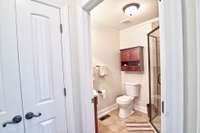 Bathroom with shower and storage closet just off of the den.