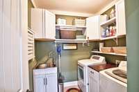 Love this convenient wash sink & extra storage in the laundry room.