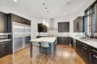 Custom kitchen with quartz counters and island.