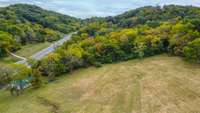 Large open area has over ~200'x150' depth buildable clearing up off the road.