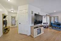 Entry hallway leading to the kitchen, dining, and open living space. Large storage closet.