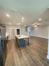 Stock photo from dining area looking into kitchen and great room