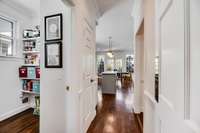 Hallway from dining room to kitchen, with laundry/storage to the left