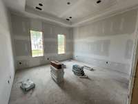 Bedroom 4 ensuite with tray ceiling  *this home is under construction photo taken 7/20/24