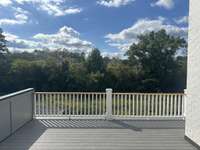 Spacious Sun deck off Bonus room and Game room. Great for entertaining with lots of privacy.  *this home is under construction Built By: Insignia Homes Photo taken 9/18/24