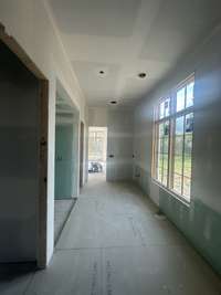 Primary Spa bath featuring double vanities, large walk-in shower with bench, free-standing tub with lots of natural light  this house is under construction Photo taken 7/20/24