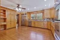 This renovated kitchen has a granite countertops, bamboo flooring, and all stainless steel appliances