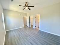 Master bedroom with attached walk-in closet and full bath