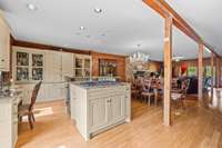 The island centerpiece in the kitchen, featuring a sleek new gas cooktop and water and ample space for four stools.