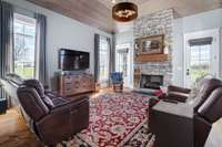 Cozy den with an amazing stone fireplace.