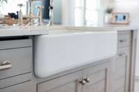 A deep farm sink in the bathroom creates a rustic elegance and a vintage charm.