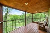 Covered and screened deck off back of home has roll down shades and just the most beautiful view. Stand out here and just listen.