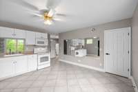 View from entry into basement at kitchen. Pantry closet to right and view beyond into laundry area.