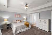 Primary bedroom with ensuite bathroom features a trey ceiling