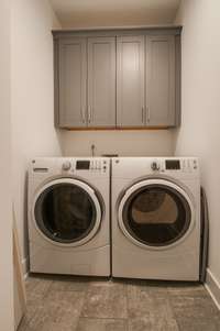 Laundry room located convenient to the bedrooms with extra storage and countertop space not pictured.