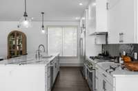 The kitchen has been carefully designed with functionality and style in mind, offering plenty of storage space in the abundance of cabinets and drawers including upper cabinets that extend all the way to the ceiling.