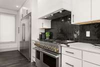 The kitchen also features a Frigidaire Professional Series side by side refrigerator and freezer which is sure to please the chef in your family.  Black herringbone tile backsplash and gorgeous Quartz countertops tie the whole design together.