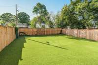 The oversized fenced backyard features a gate with easy alley access and professionally installed artificial turf and drainage system, allowing you to enjoy your time outdoors without having to worry about lawn maintenance or landscaping.