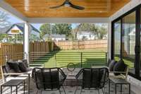 Notice the tongue-and-groove stained wood ceiling to match the side covered porch.