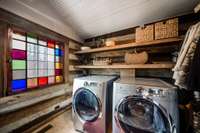 Beautiful laundry room with a beautiful stained glass window.