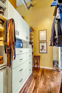 The primary bedroom has a large walk-in closet, fully outfitted with a closet design system.