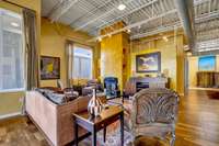 View of living room shows lighted wall niches, ideal for displaying art.