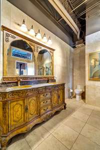 The richly stained and carved vanity has double sinks.