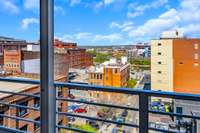 The L-shaped, wrap-around balcony has both city and river-facing views.