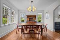 Natural light floods the dining room, infusing the space with an inviting radiance that elevates the dining experience, making it a cherished gathering spot for family and friends.