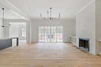 Large open living room with plaster fireplace and white oak open shelving