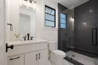 The in-house apartment offers a full bathroom with a tiled shower.