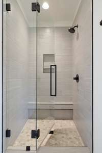 A view of the beautiful tile work in the shower.