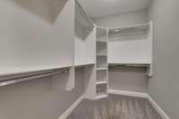 Custom built-in closets in the primary bedroom provide ample storage