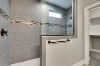 Extra large, luxurious, custom, walk-in shower in the Primary Suite