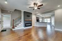 Large living room features newly installed electric fireplace and feature wall (2022).