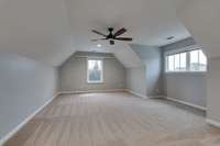 Large bonus room upstairs for all your entertaining needs!  It even comes with a projector and pull down screen.