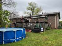 Rear view of the home.  Pool to remain.