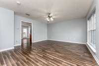 Spacious living room with laminate flooring.