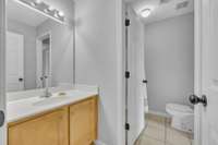 Upstairs Bathroom with separation between Sink/vanity and tub/shower combo.