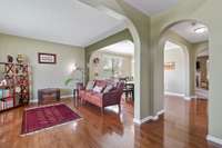 Den area with large soft curve arches for a flowing open floor plan on main level. Nice decorator paint colors
