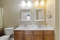 Double vanities in hall bath upstairs with tub/shower combo.